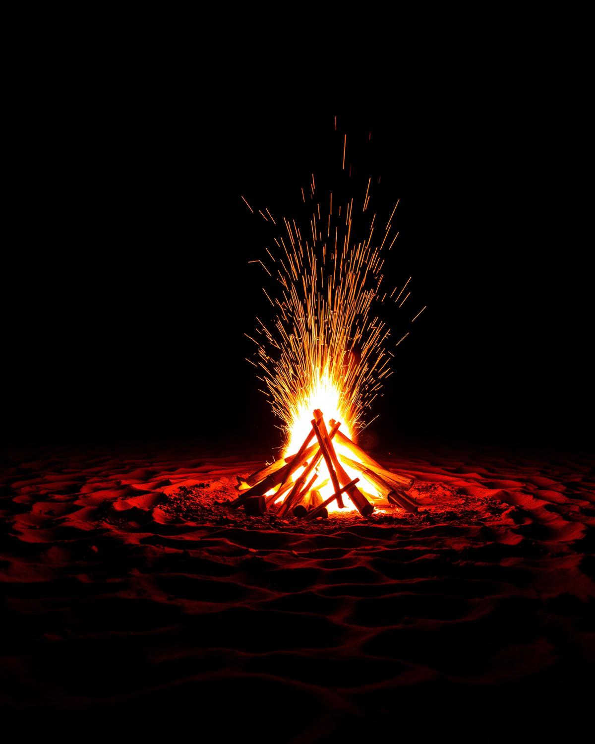 Friends around a bonfire after dark
